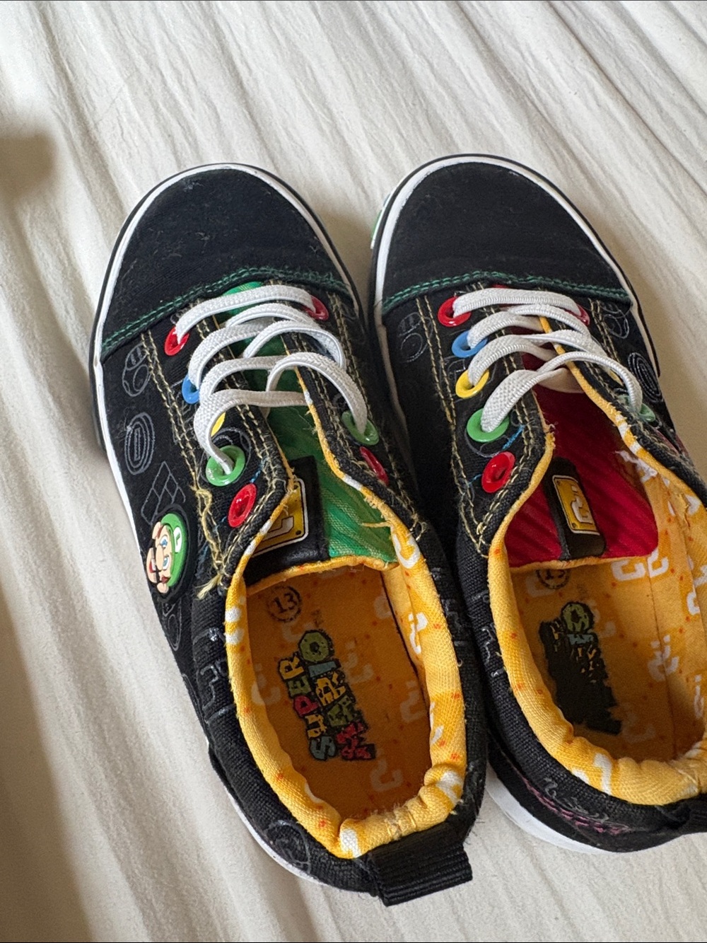 Nintendo Black Kids Sneakers with Multicolor Eyelets and Yellow Lining